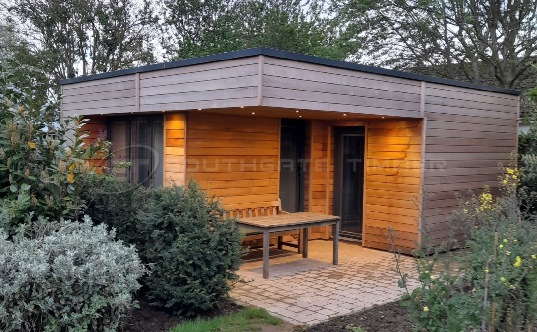 Weathered Western Red Cedar cladding on a modern garden room, highlighting how untreated cedar naturally fades and changes over time.